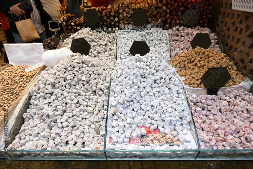 Rows of different types of Turkish delight also called lokum in a stall in front of a shop in traditional Egyptian Bazaar food market in Istanbul, Turkey photo