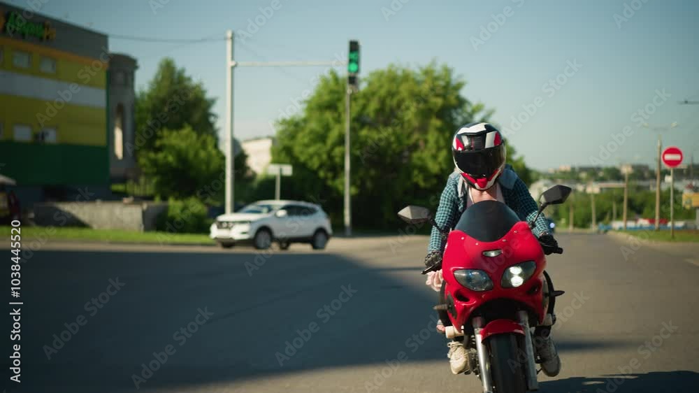 Two ladies ride a power bike with helmets, navigating a smooth tarred road while the wind blows their cloth behind, an SUV car slowly bends in the background with signposts Two ladies ride a power bike with helmets, navigating a smooth tarred road while the wind blows their cloth behind, an SUV car slowly bends in the background with signposts