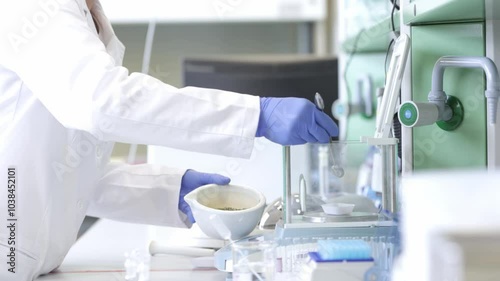 Biochemist using scale for correct weight of the mixture in the laboratory, chemical industry