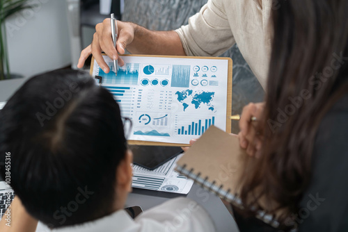 Data analysts team of office worker collaborate on business intelligence BI dashboard to analyze financial, trend, and marketing data. BI software utilization drive business success. Prudent