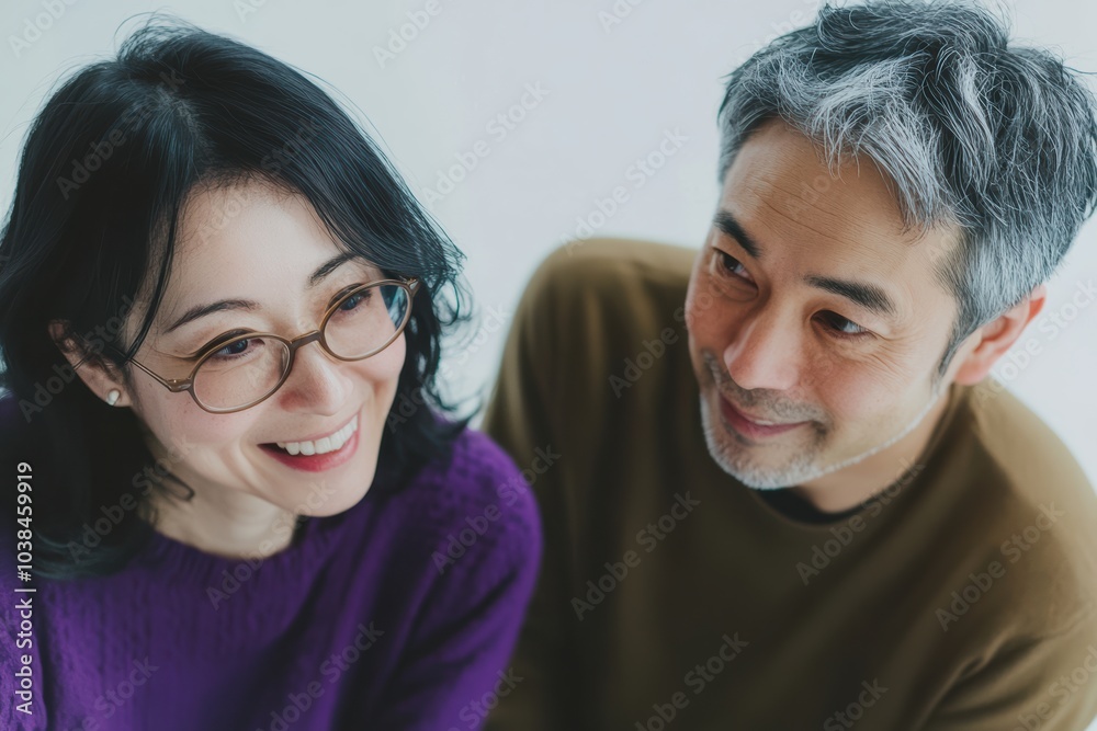 a couple dressed in matching purple on a white background with above view shot. Their posture symbolize unity, harmony, making it a heartwarming depiction of a lasting relationship. a couple dressed in matching purple on a white background with above view shot. Their posture symbolize unity, harmony, making it a heartwarming depiction of a lasting relationship.