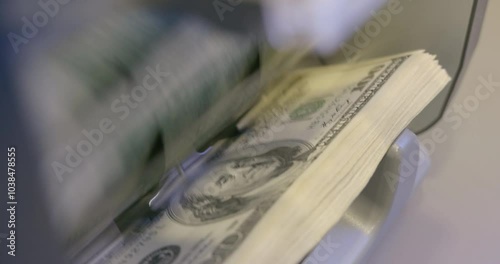 100 dollar bills counted in money counting machine. Cash money dollars into banknote counter. High quality video 6k 4:2:2 10bit downscale 4k 