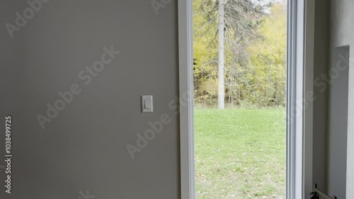Indoor View of Autumn Backyard Through Open Door