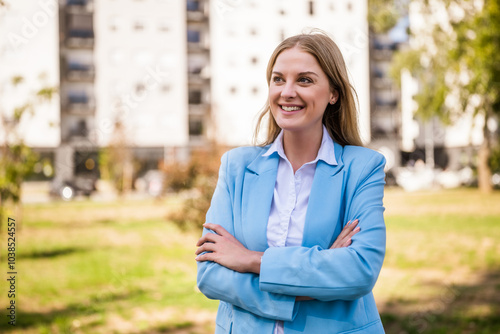 Portrait of confident businesswoman with arms crossed standing outdoor. 