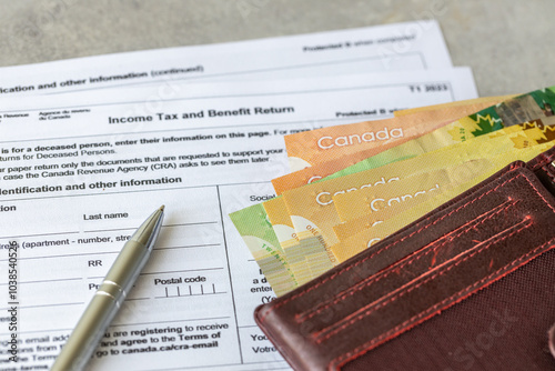 Obraz na płótnie Income tax return in Canada. Financial concept. Tax form, Canadian dollars and tax calculation on calculator. close up w salonie