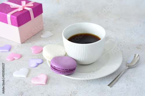 a cup of coffee and a box of chocolates and some pink and blue silk hearts 