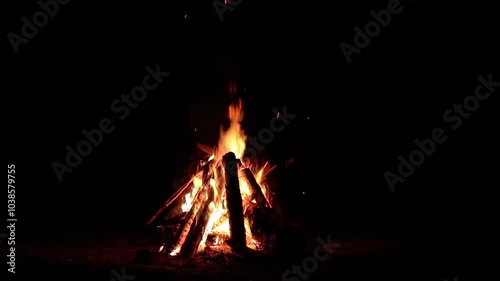 Night Bonfire Burns in the Dark Forest - Isolated on Black. Slow Motion. Flaming Campfire at Nighttime. Place for Bonfire. Fire Pit Outdoors, Wood on Fire, Flying Sparks and Smoke - Static Shot