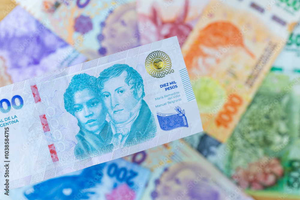 Argentina money. New 10,000 pesos banknote against the background of other Argentine pesos. Financial business concept, close up