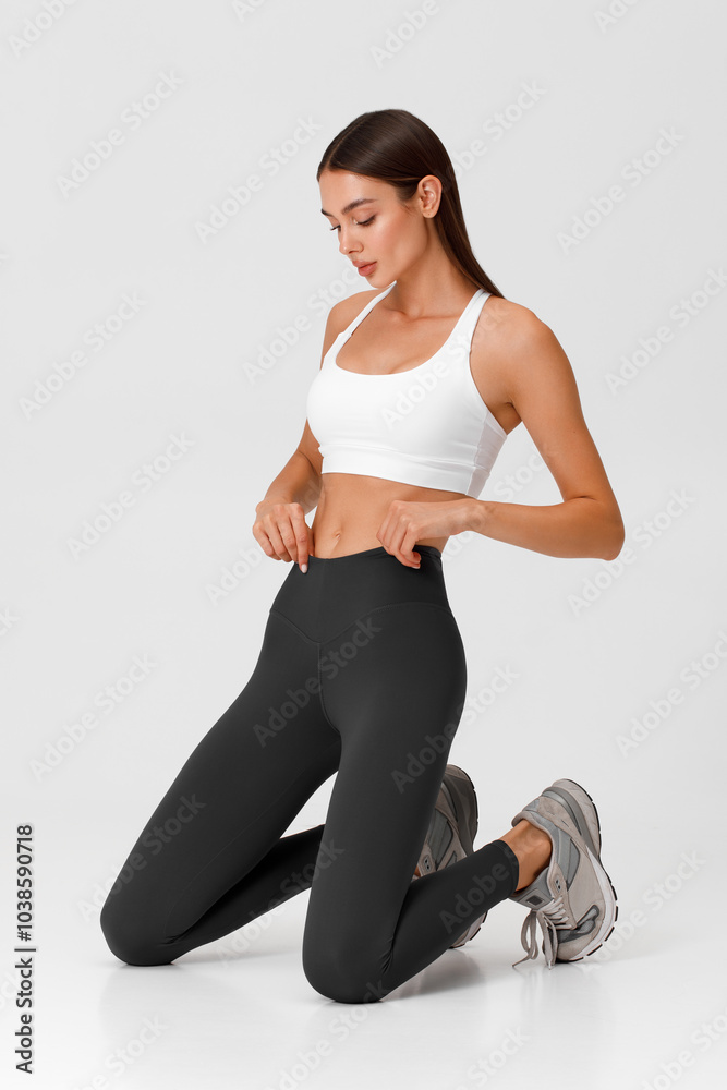 Fitness woman. Athletic girl on the gray background Fitness woman. Athletic girl on the gray background