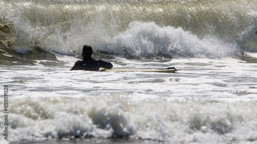 Canvas Print Surfer Navigating Powerful Waves at a Beach on a Sunny Afternoon