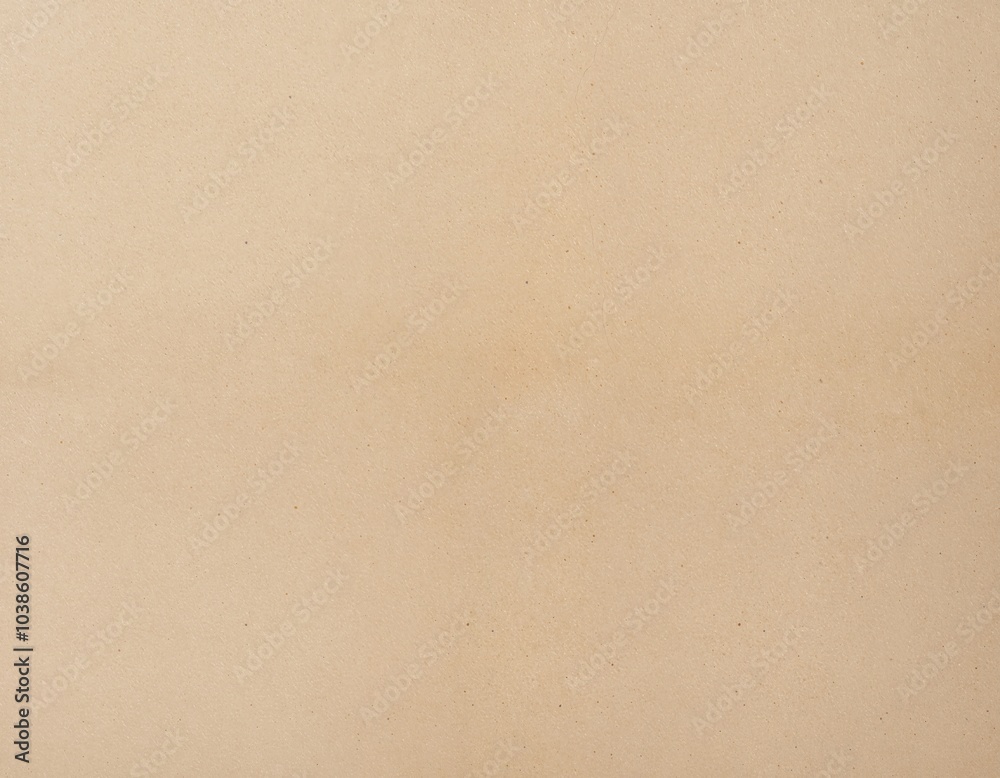 The image features a close-up, light beige background with a subtle texture, featuring a single, small, dark spot on the left side, creating a minimalist, minimalist aesthetic