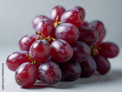 Bunch of red grapes are sitting on a table photo