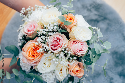 Wedding beautiful bouquet of roses in the hands of the bride, wedding rings