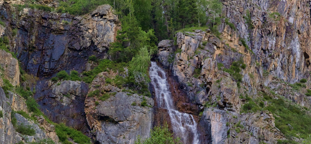 Obraz premium landscape with waterfall between dark rocks