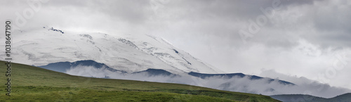 Elbrus mountain peaks in grey clowds photo