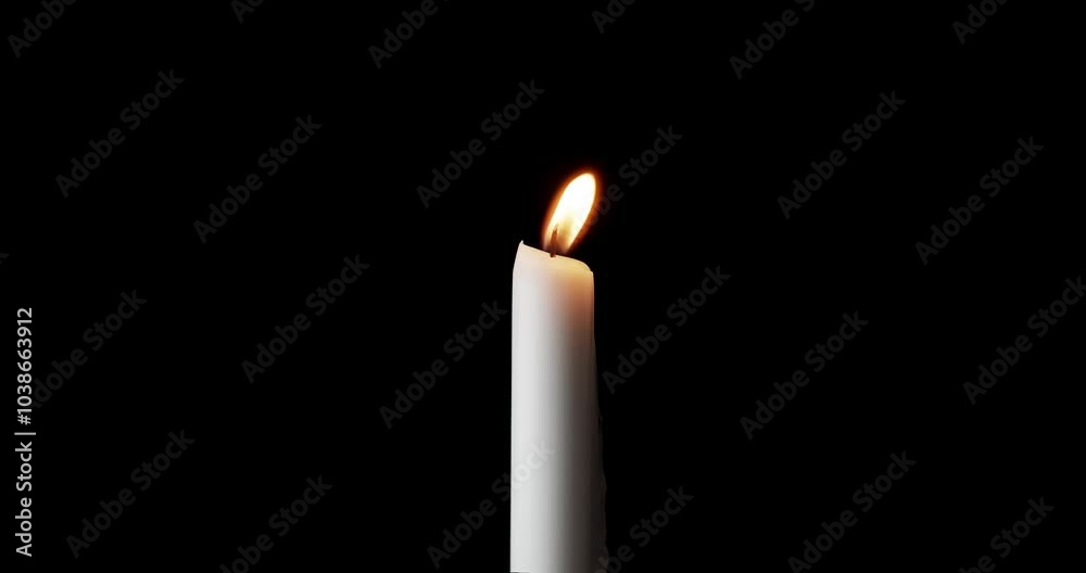 A single white candle burning. Isolated candle slow motion burning with dark background. White paraffin candle with yellow shades burns on a black background. Slow motion. A single white candle burning. Isolated candle slow motion burning with dark background. White paraffin candle with yellow shades burns on a black background. Slow motion.
