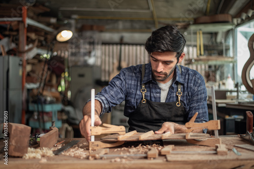 Bilde på lerret Luthier creating a guitar, clamps on the body of a guitar under construction imp