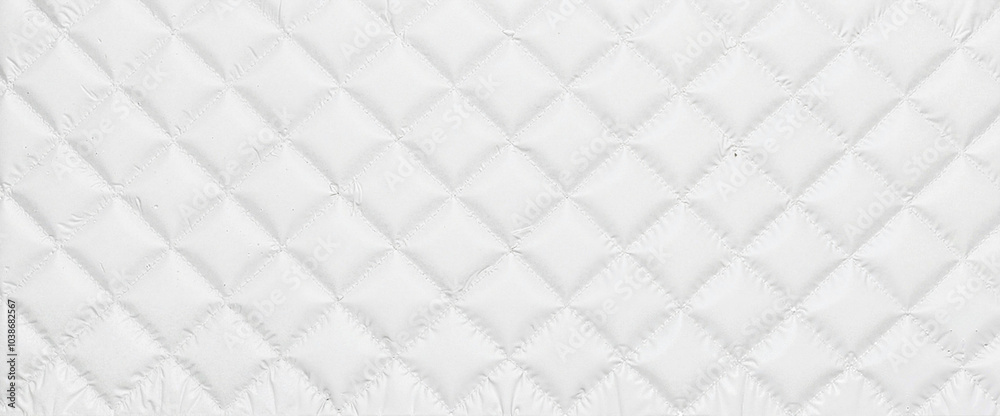 Textured white quilted fabric background with diamond pattern Textured white quilted fabric background with diamond pattern