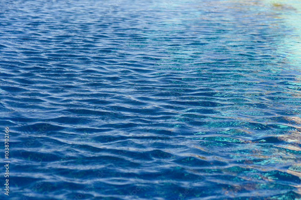 Rippling turquoise water reflects sunlight, creating a mesmerizing dance of light on a calm afternoon Rippling turquoise water reflects sunlight, creating a mesmerizing dance of light on a calm afternoon