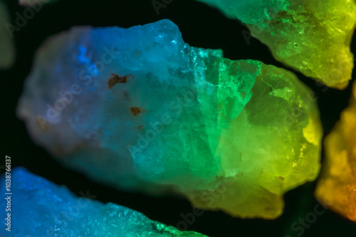 clear quartz crystal close up in green prism light