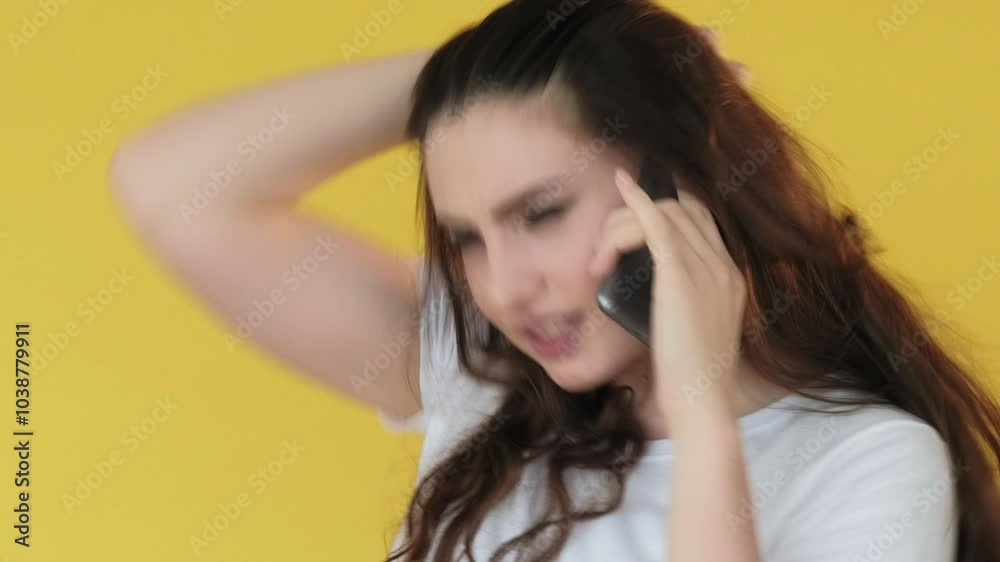 Mobile conflict. Angry conversation. Communication problem. Frustrated annoyed woman yelling talking on phone isolated on yellow. Mobile conflict. Angry conversation. Communication problem. Frustrated annoyed woman yelling talking on phone isolated on yellow.