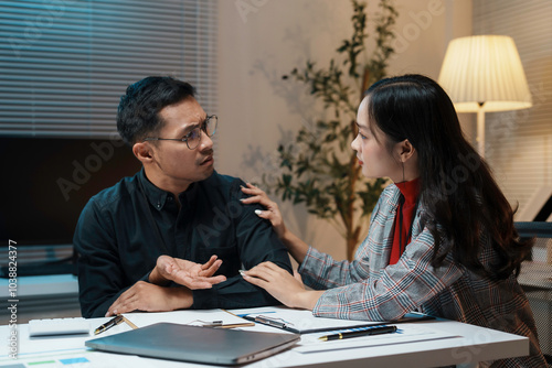 Businesswoman comforting her stressed colleague while working late in the office