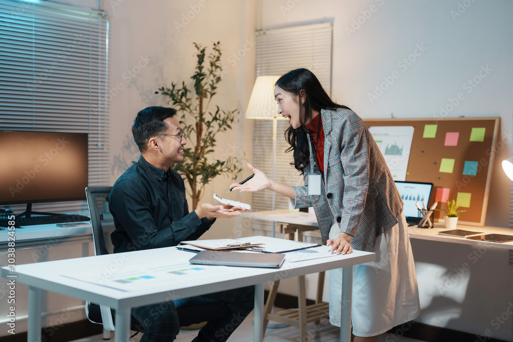 Businesswoman is standing at her desk and arguing with a male colleague about a work project late at night Businesswoman is standing at her desk and arguing with a male colleague about a work project late at night