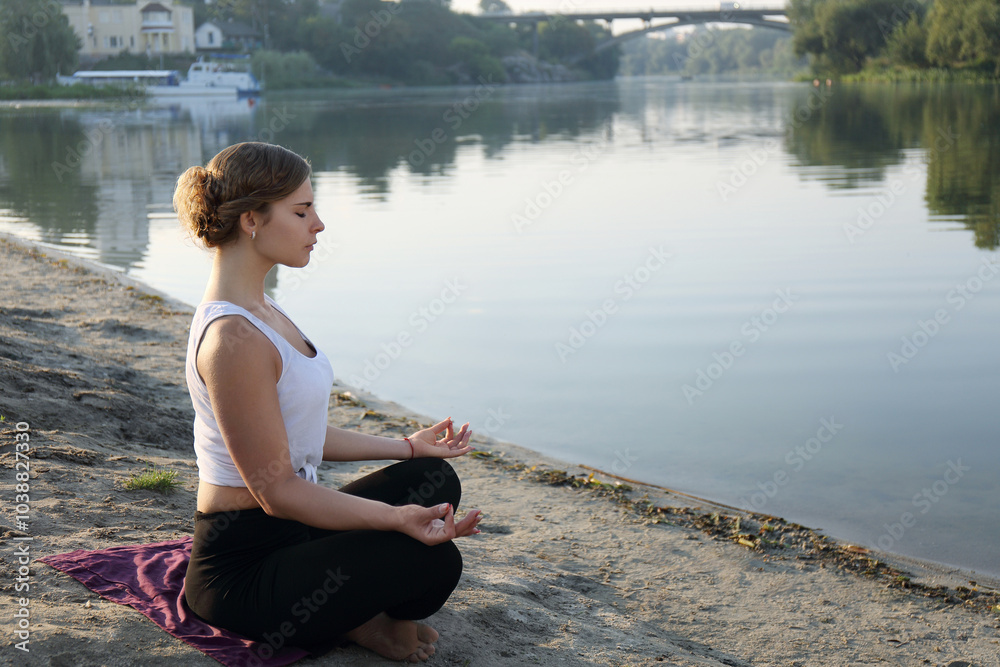 A woman on the beach and meditating