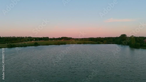 Aerial footage of Furzton Lake and the National Bowl at sunset in Milton Keynes, England, UK photo