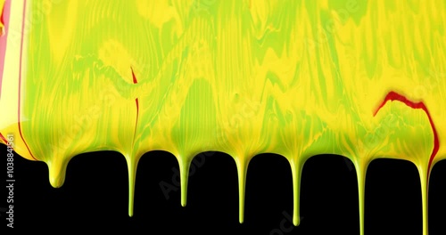 green and yellow paint dripping and flowing in dynamic slow motion, creating a vibrant and abstract scene