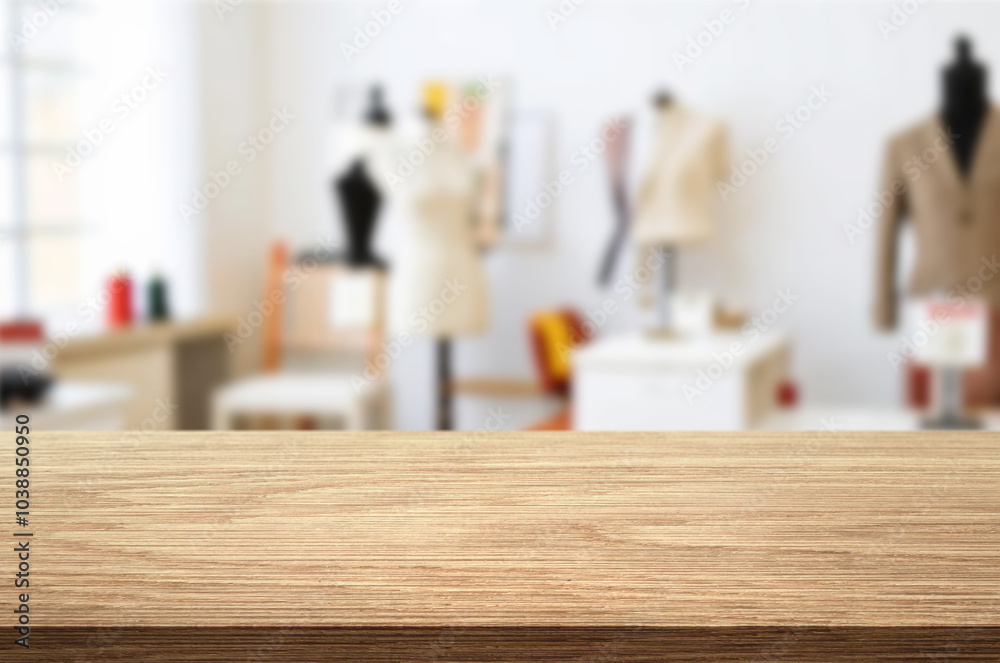 Blur Sunny Fashion Design Studio and wooden table top. We See, Hanging Clothes, Sewing Machine and Various Sewing Related Items on the Table, Mannequins Standing, Colorful Fabrics. Blur Sunny Fashion Design Studio and wooden table top. We See, Hanging Clothes, Sewing Machine and Various Sewing Related Items on the Table, Mannequins Standing, Colorful Fabrics.
