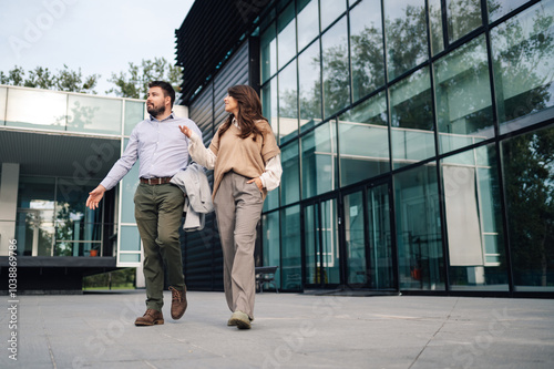 Business people walking and talking outside office building