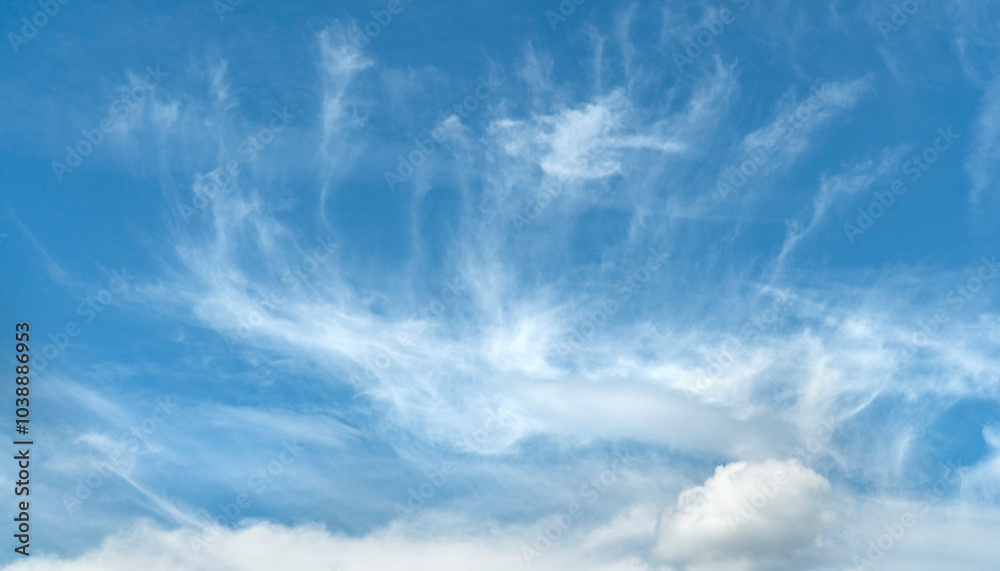Whimsical wisps of clouds dance across a serene blue sky during a tranquil afternoon Whimsical wisps of clouds dance across a serene blue sky during a tranquil afternoon