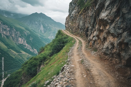 Steep perilous mountain path to a remote Caucasus village Hazardous narrow trail beside sharp rocks and cliffs