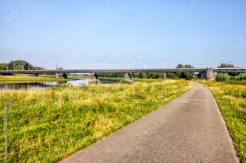 Arnhem, Netherlands - August 1, 2024: Landscapes of a pond and distant buildings in Arnhem, Netherlands
 photo