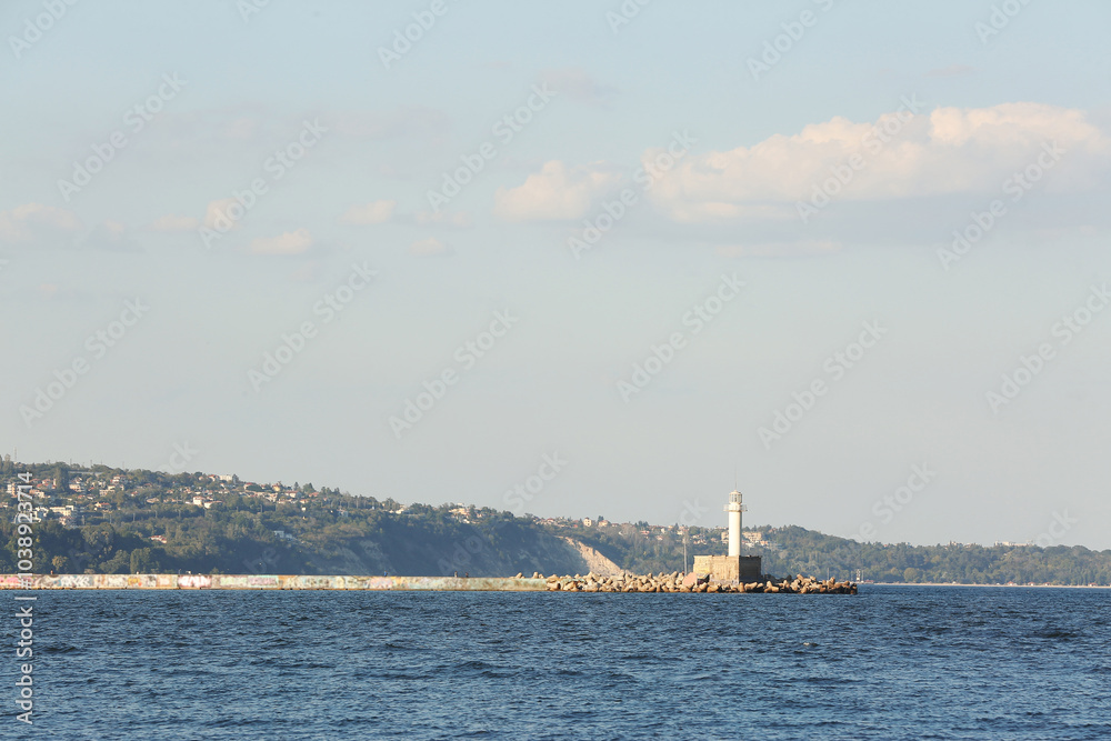 Seascape with lighthouse and breakwaters Seascape with lighthouse and breakwaters