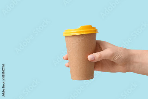Female hand holding paper c...