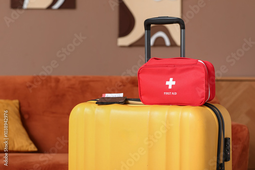 Suitcase with first aid kit and passport in room photo