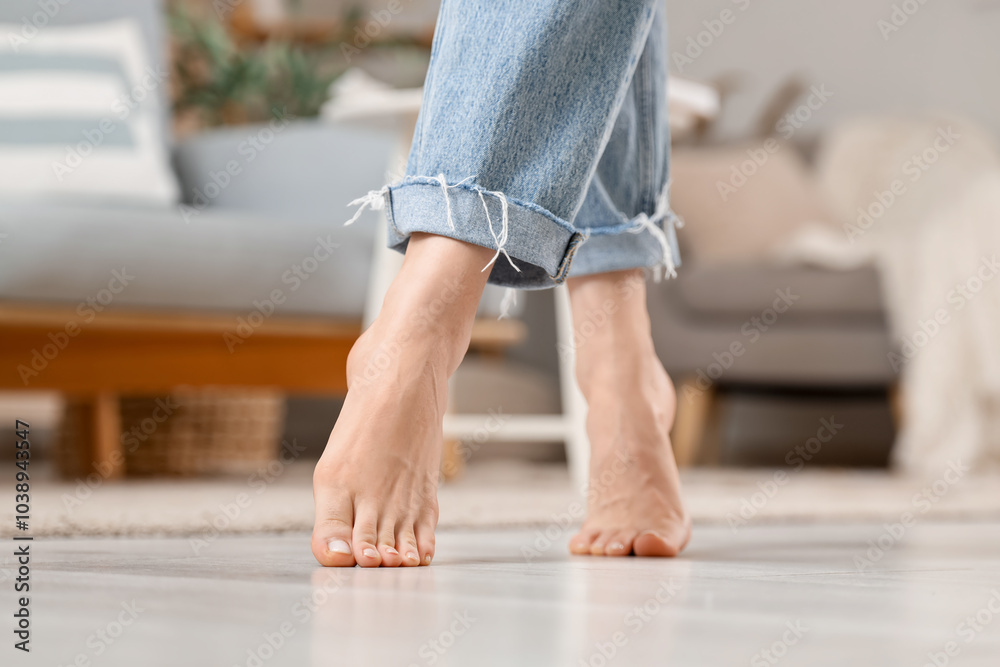 Young woman with flat feet on floor at home, closeup Young woman with flat feet on floor at home, closeup