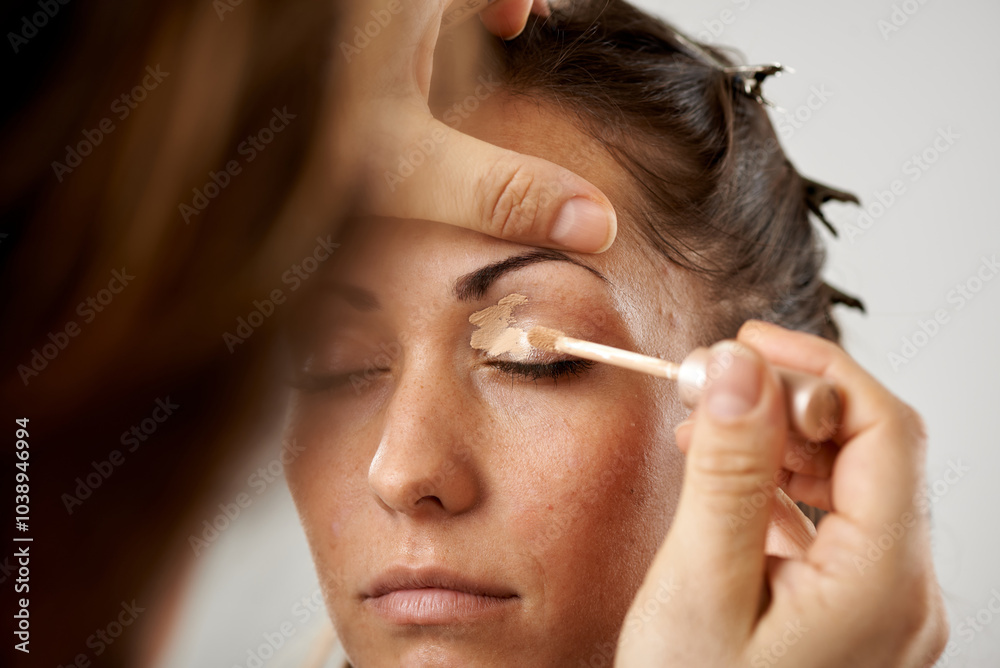 Makeup Artist Applying Eye shadow To Model's Eyelid Makeup Artist Applying Eye shadow To Model's Eyelid