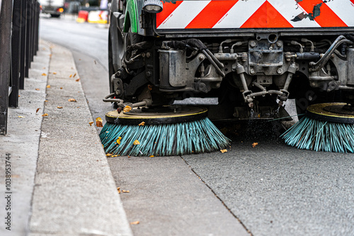 Fototapeta Naklejka Na Ścianę i Meble -  Paris, France - 15 September 2022: Street cleaning machine gathers trash, garbage and leaves