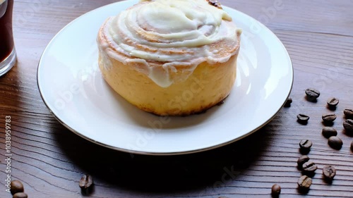 Wallpaper Mural Cinnamon roll on a plate on a wooden background with a glass of espresso next to it Torontodigital.ca