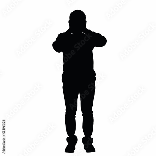 A silhouette of a person standing with their hands covering their face