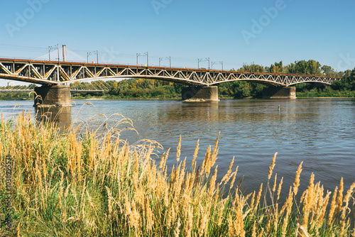 Swietokrzyski bridge over the Vistula river in Warsaw, Poland in a bright sunny day photo