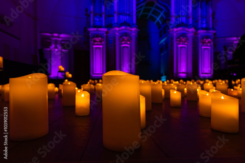 blurred symphonic orchestra on stage with lots of candles