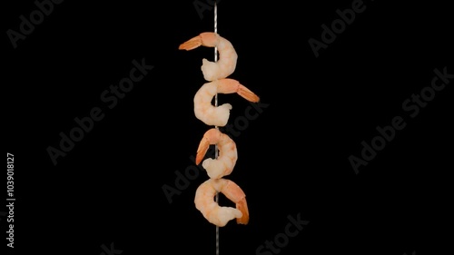 Grilled shrimp on skewer on black background. Seafood.