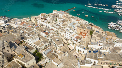 Aerial view of houses, apartments and buildings in the historic center of Otranto in the province of Lecce, Salento, Puglia, Italy. In the background the Mediterranean Sea.