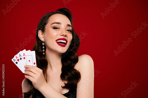 Photo of happy rich wealthy lady showing cards poker club proffesional game isolated on red color background photo