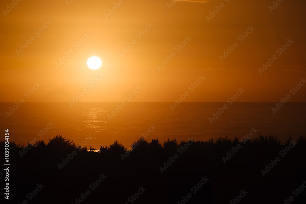 Beautiful sunset on the Oregon coast, orange glow and reflections Beautiful sunset on the Oregon coast, orange glow and reflections