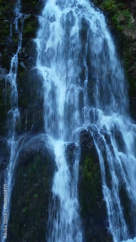 A Serene Mountain Waterfall Cascading Down Beautiful Rocks in a Picturesque Natural Oasis A Serene Mountain Waterfall Cascading Down Beautiful Rocks in a Picturesque Natural Oasis
